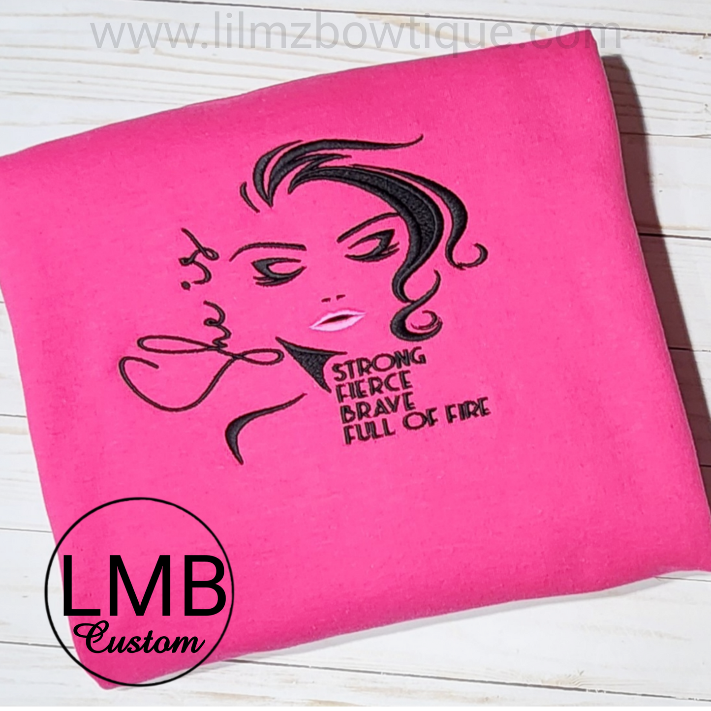 Pink adult sweatshirt with embroidered "She is strong" design