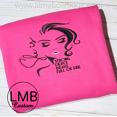 Pink adult sweatshirt with embroidered "She is strong" design