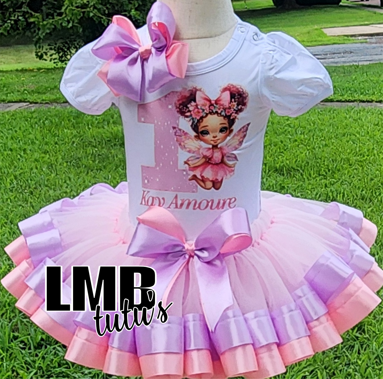 Pink and lavender fairy tutu outfit with puff sleeves and decorative bows on a mannequin